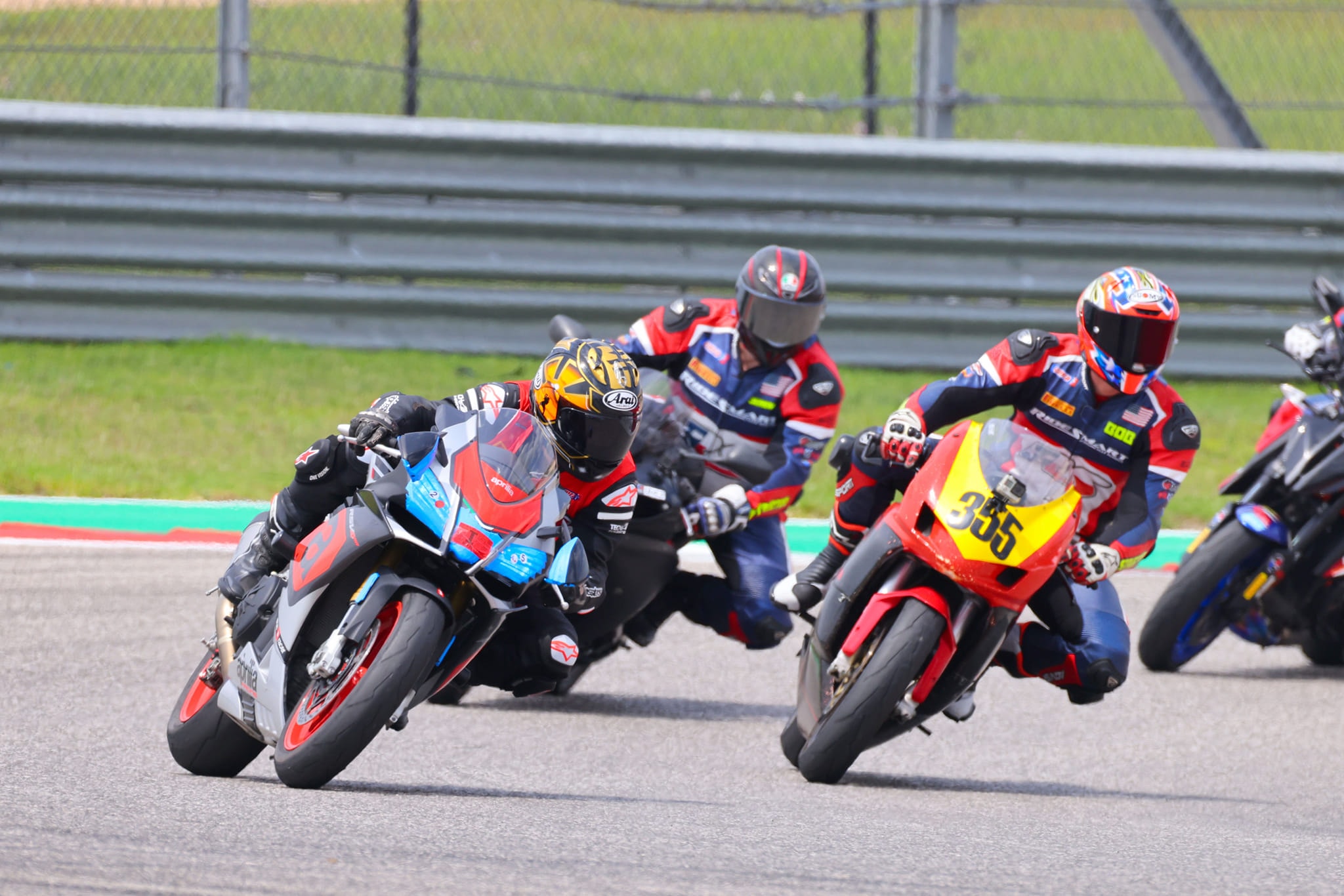 RideSmart riders and instructors sharing a corner on track